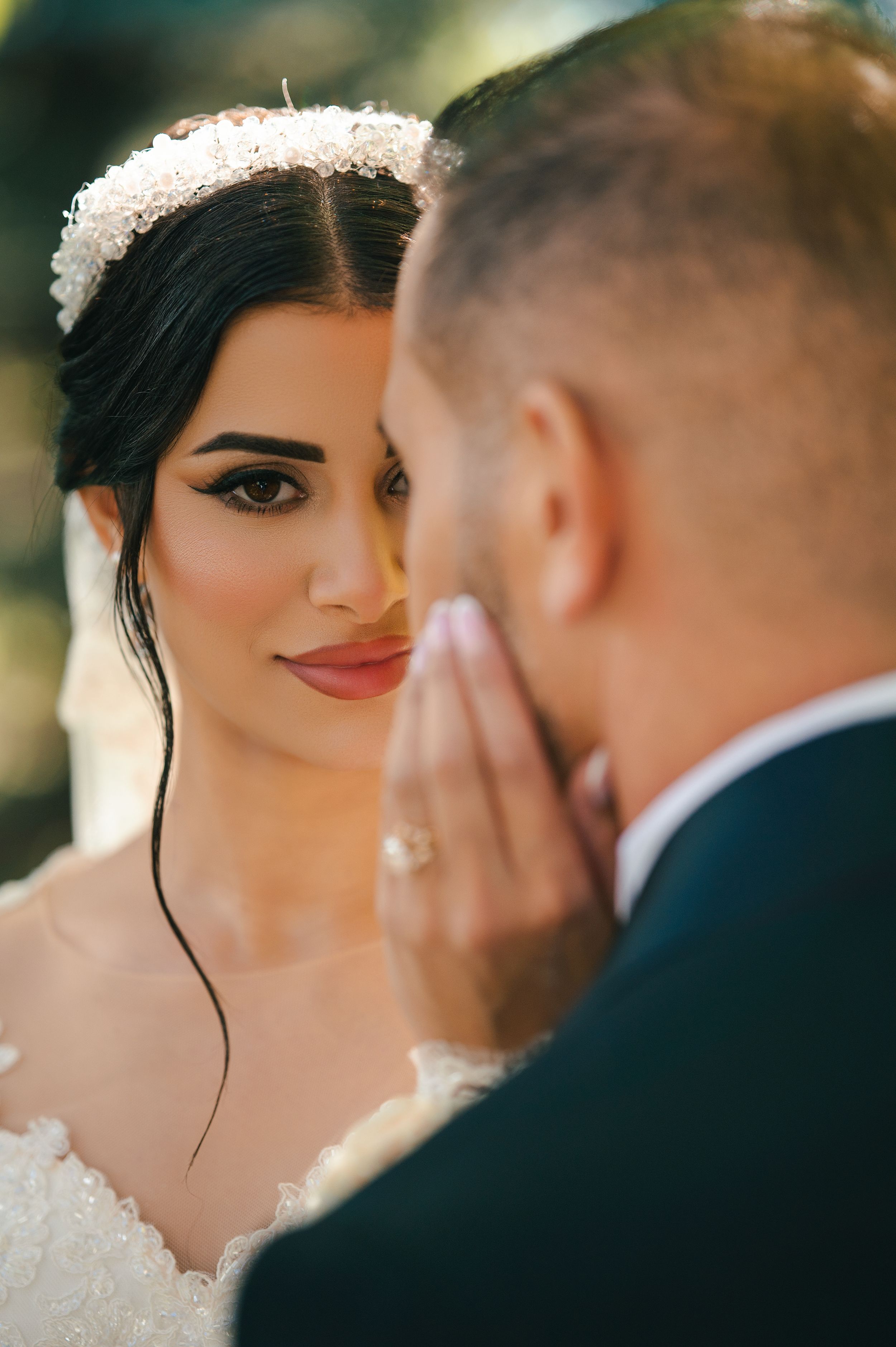 Intimate close-up wedding portrait with soft natural lighting and delicate veil details.