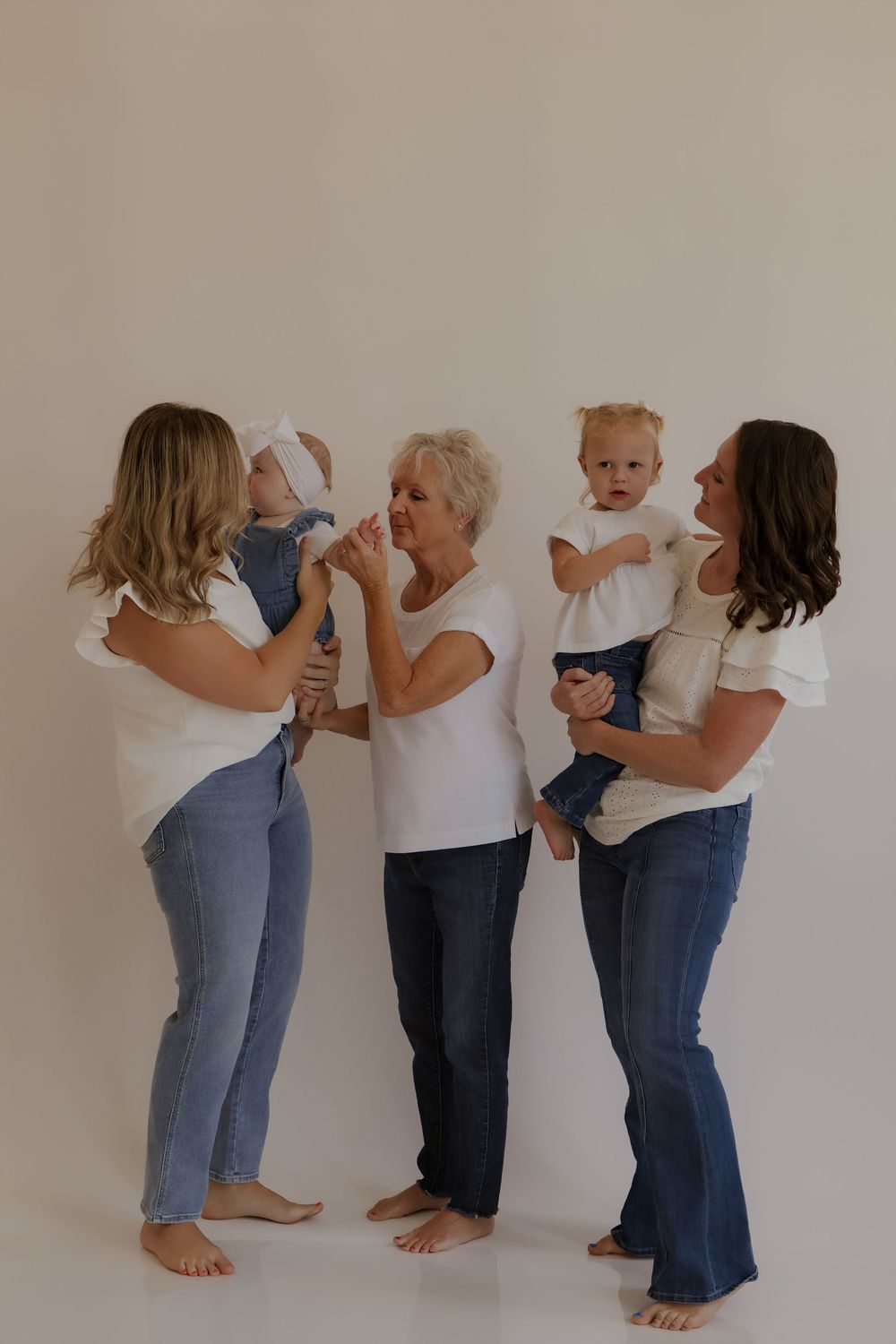 Sequence showing adults helping a small child practice walking steps against neutral background.