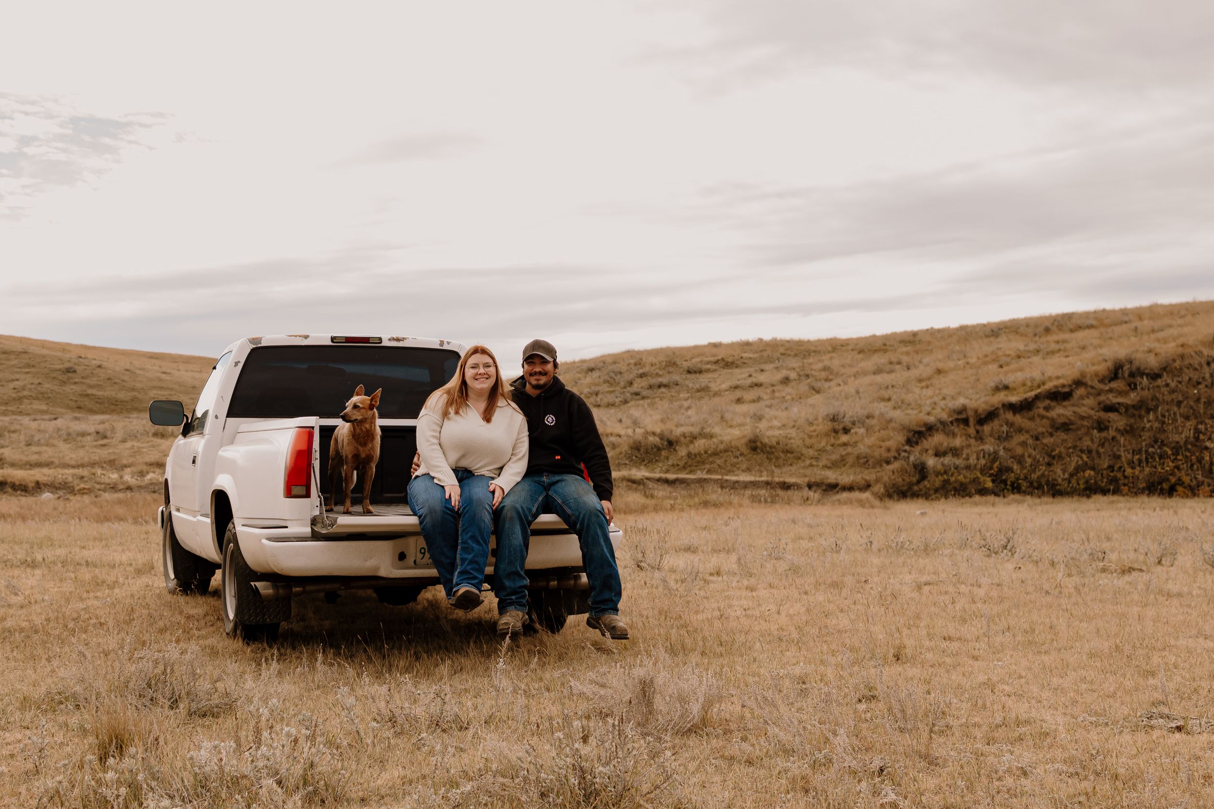 A series of candid moments captured in a desert landscape with people sitting on pickup trucks at sunset.