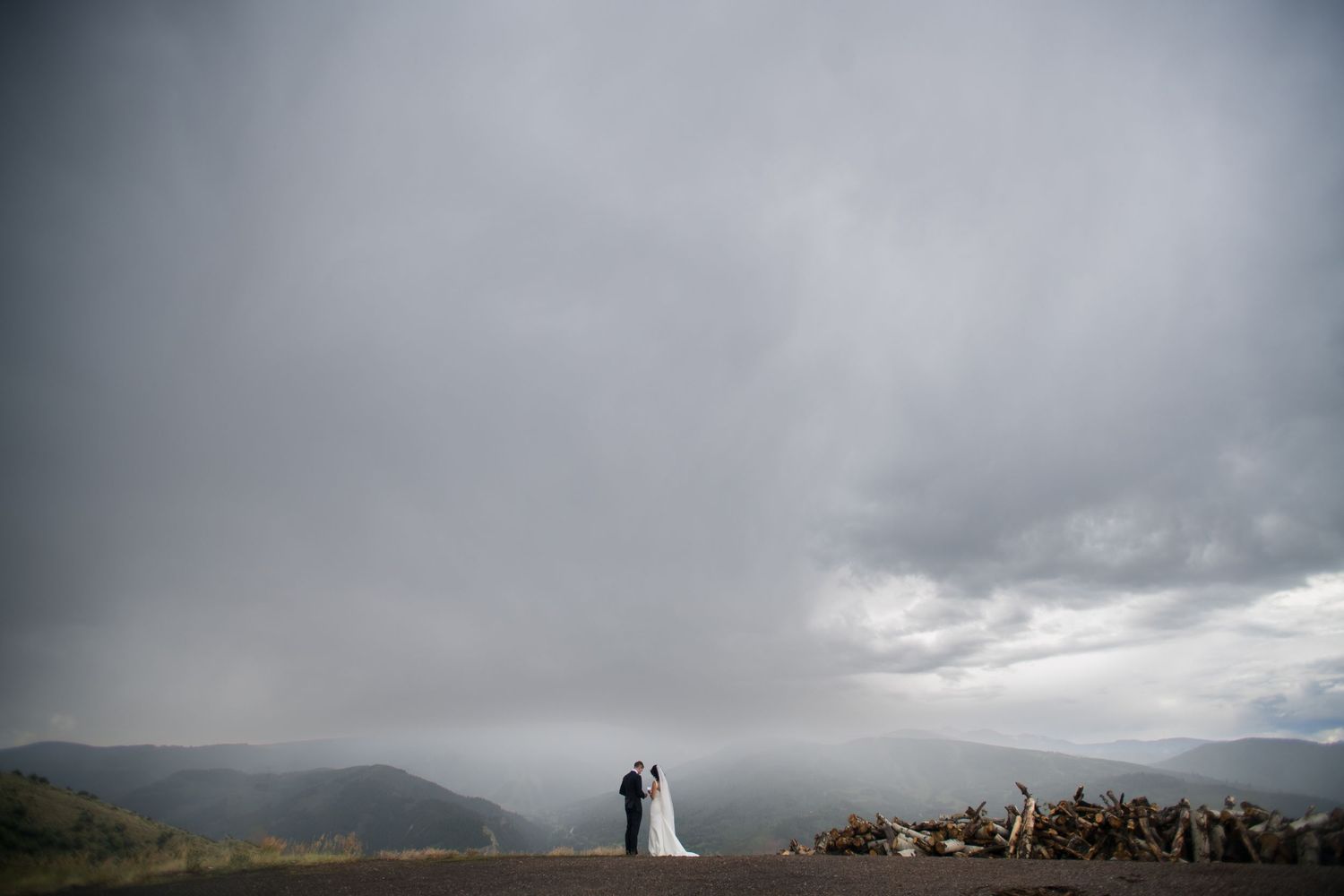 Stormy mountain landscape with dramatic clouds rolling over peaks.