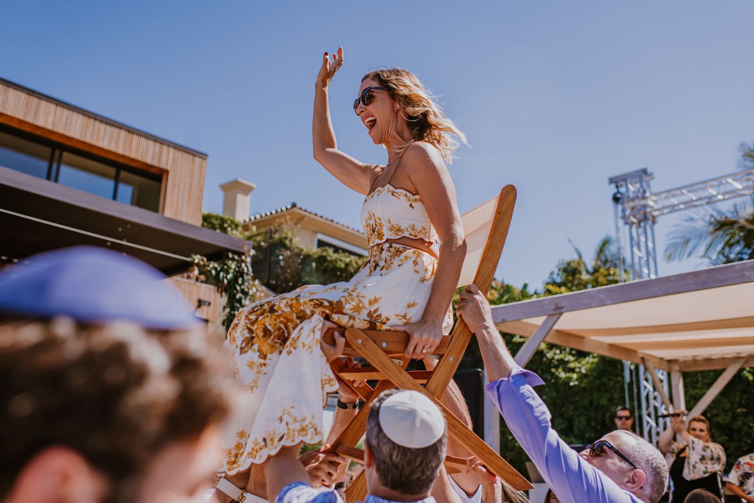 Woman getting lifted up on a chair at a Bat Mitzvah event in Orange County