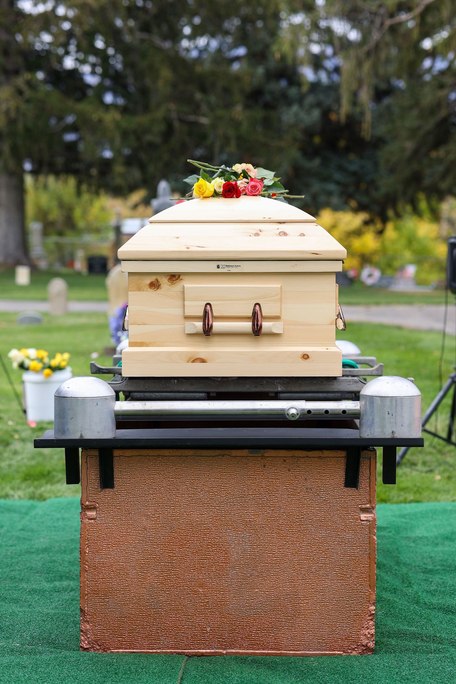 Wooden casket at graveside service