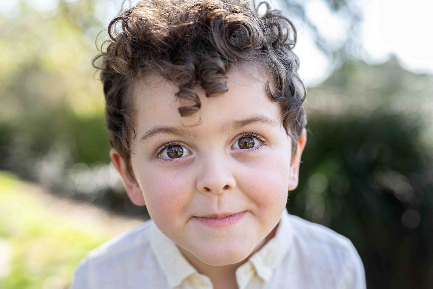 Artistic timeless portrait of a 3-year old boy in beautiful soft flattering light at an outdoor popup in Perth