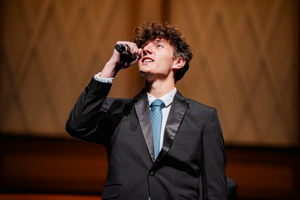 A guy singing into a microphone
