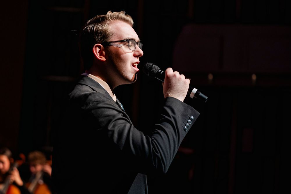 A guy singing into a microphone