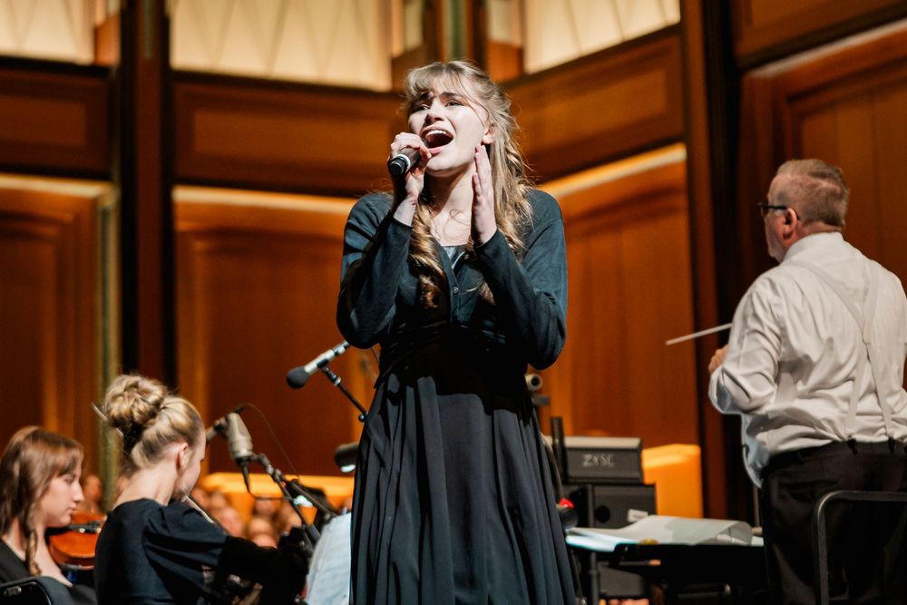 a girl singing into a microphone