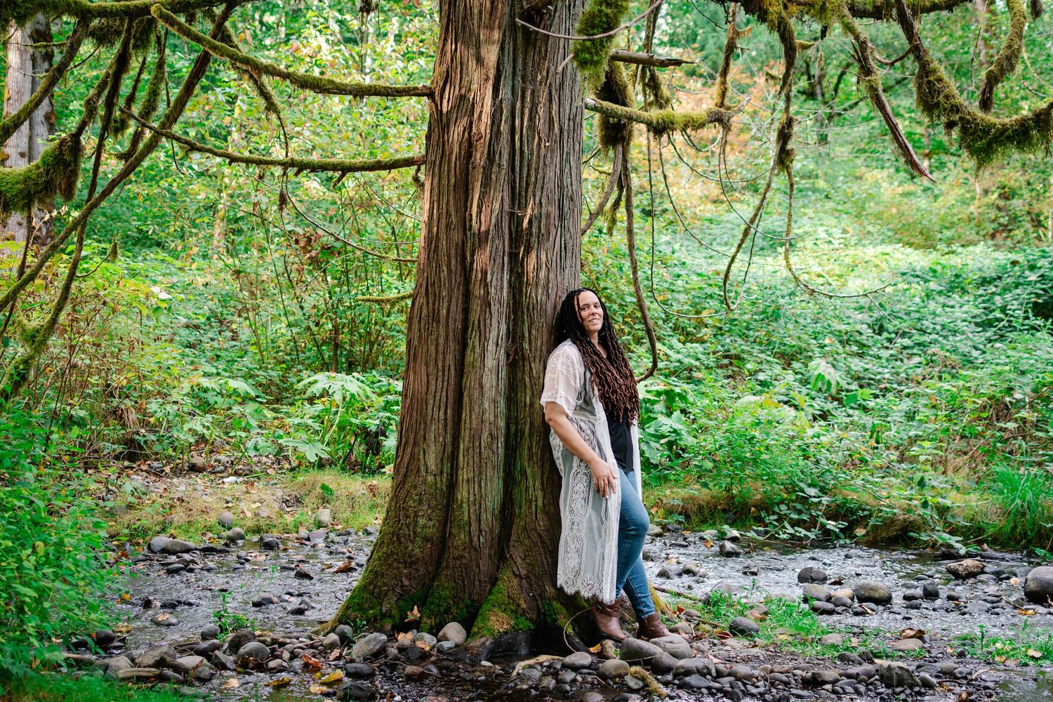 Outdoor portrait of woman standing among tall trees at Flaming Geyser State Park in Auburn, WA during golden hour.