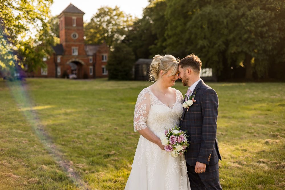 Romantic wedding portraits with red brick building and natural scenery.