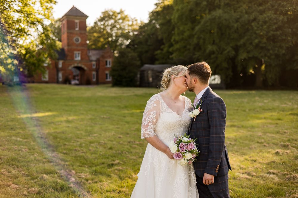 Wedding photography session with historic architecture and natural landscape.