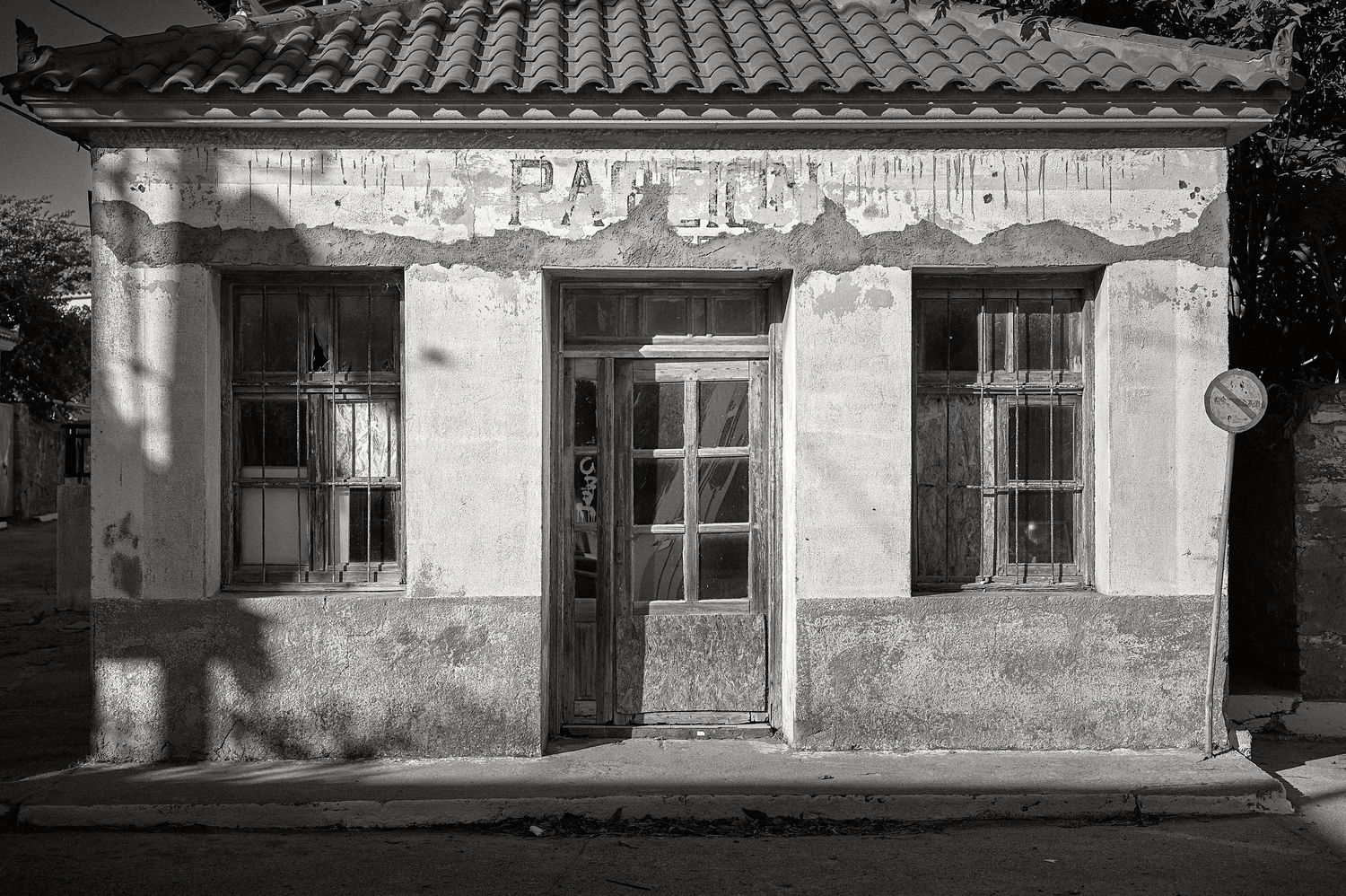 A series of black and white landscape photographs showing abandoned rural buildings and overgrown paths.