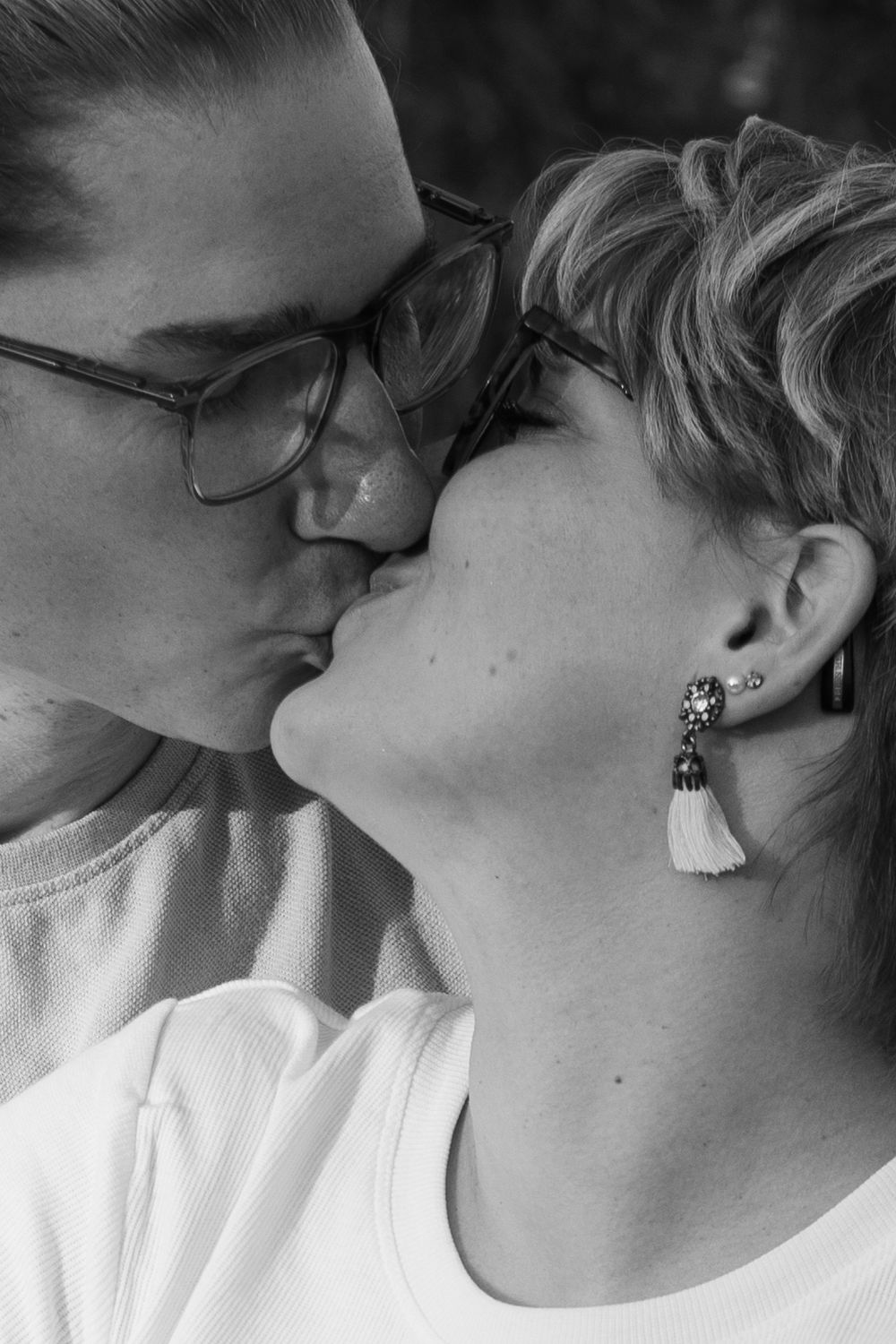 A series of black and white close-up photos showing intimate romantic kisses between a couple.