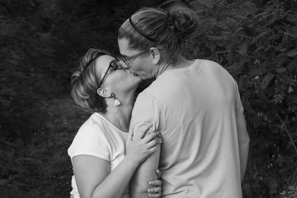 A series of intimate black and white photographs showing tender romantic moments between couples.