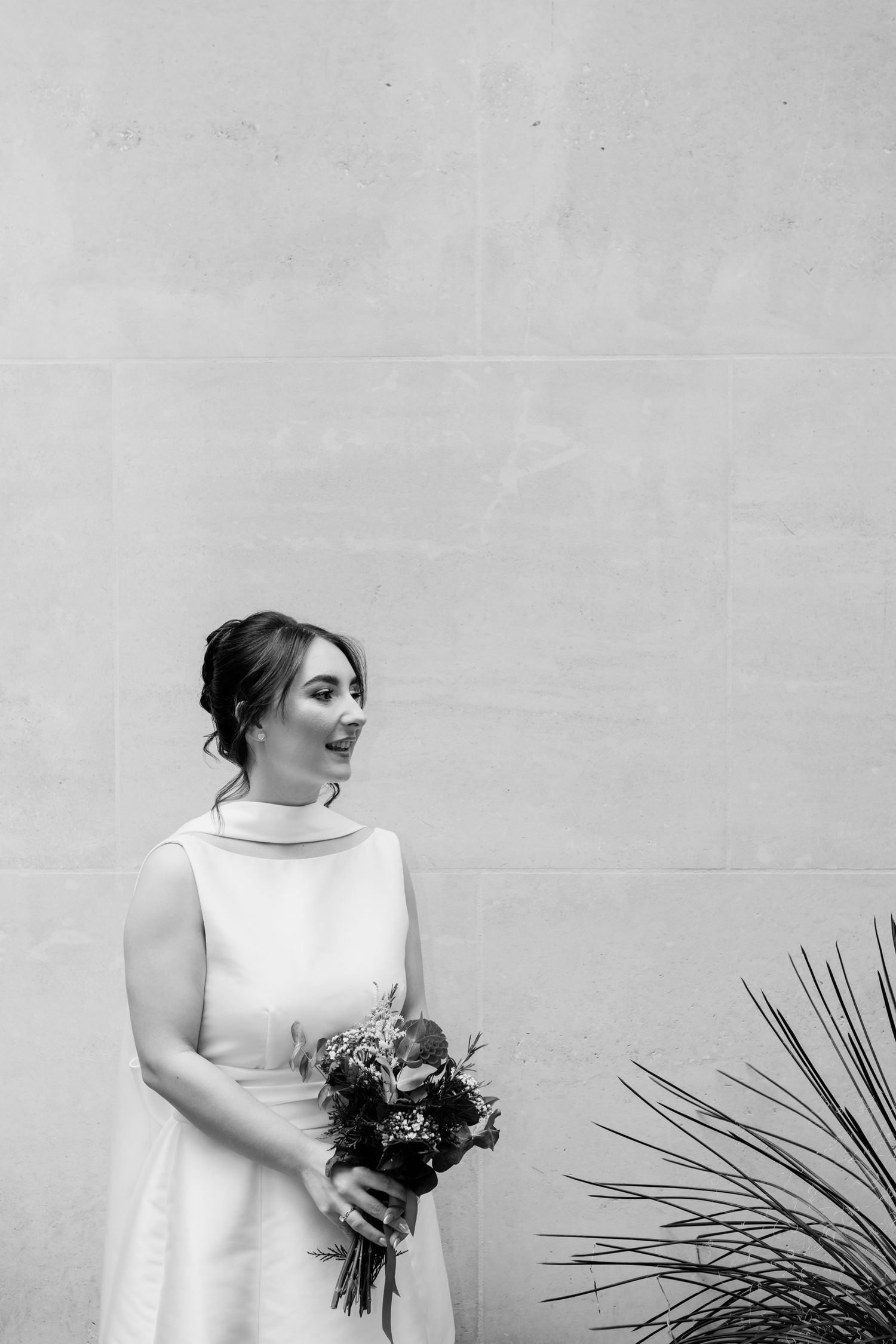 A series of black and white photos showing a person in a white sleeveless dress holding a bouquet against a light wall.