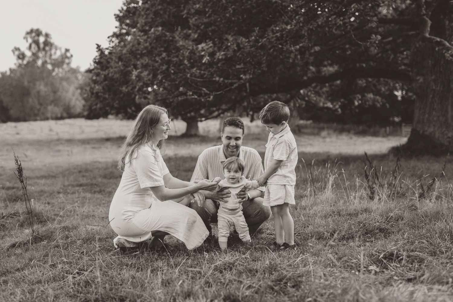 A collection of vintage black and white photographs showing people relaxing and playing outdoors in a pastoral setting.