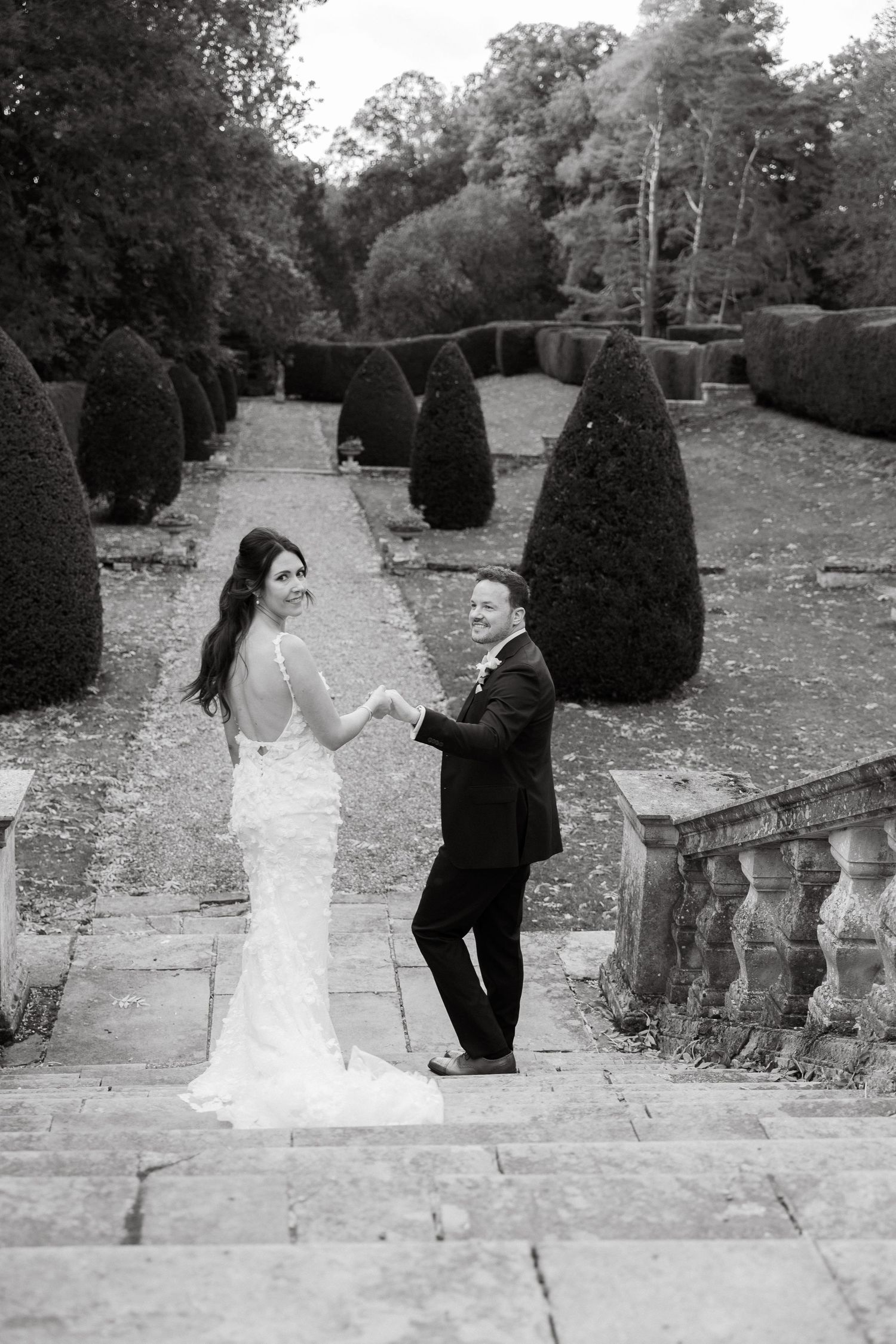Black and white photos of a couple on stone garden steps.