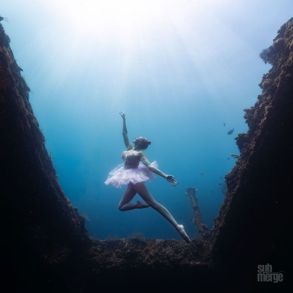 Underwater dancer in white dress gracefully poses against dark rocky backdrop in sequence of artistic shots.