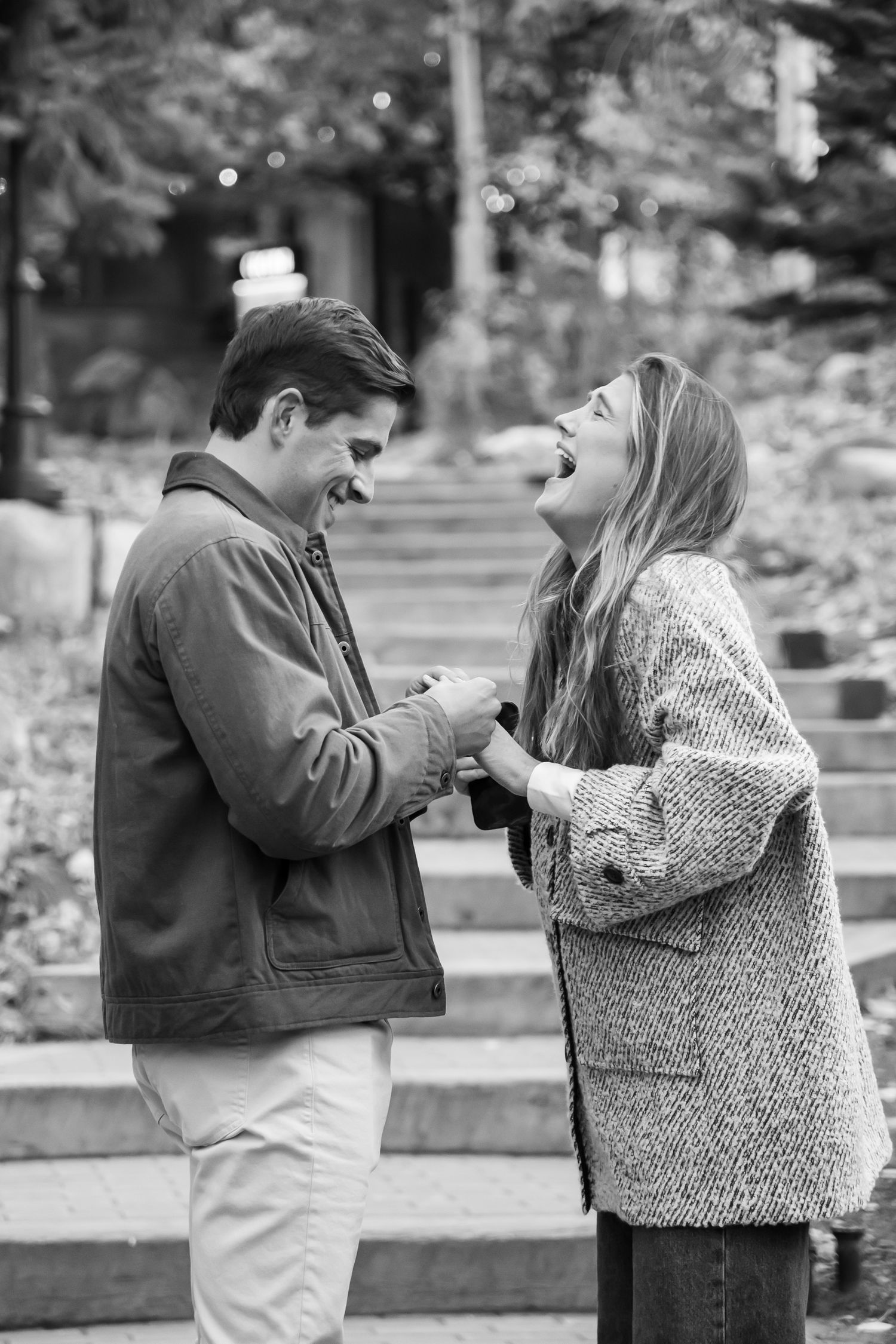 Artful photo of a happy woman reacting to a surprise proposal on a cute staircase in Vail Village Colorado