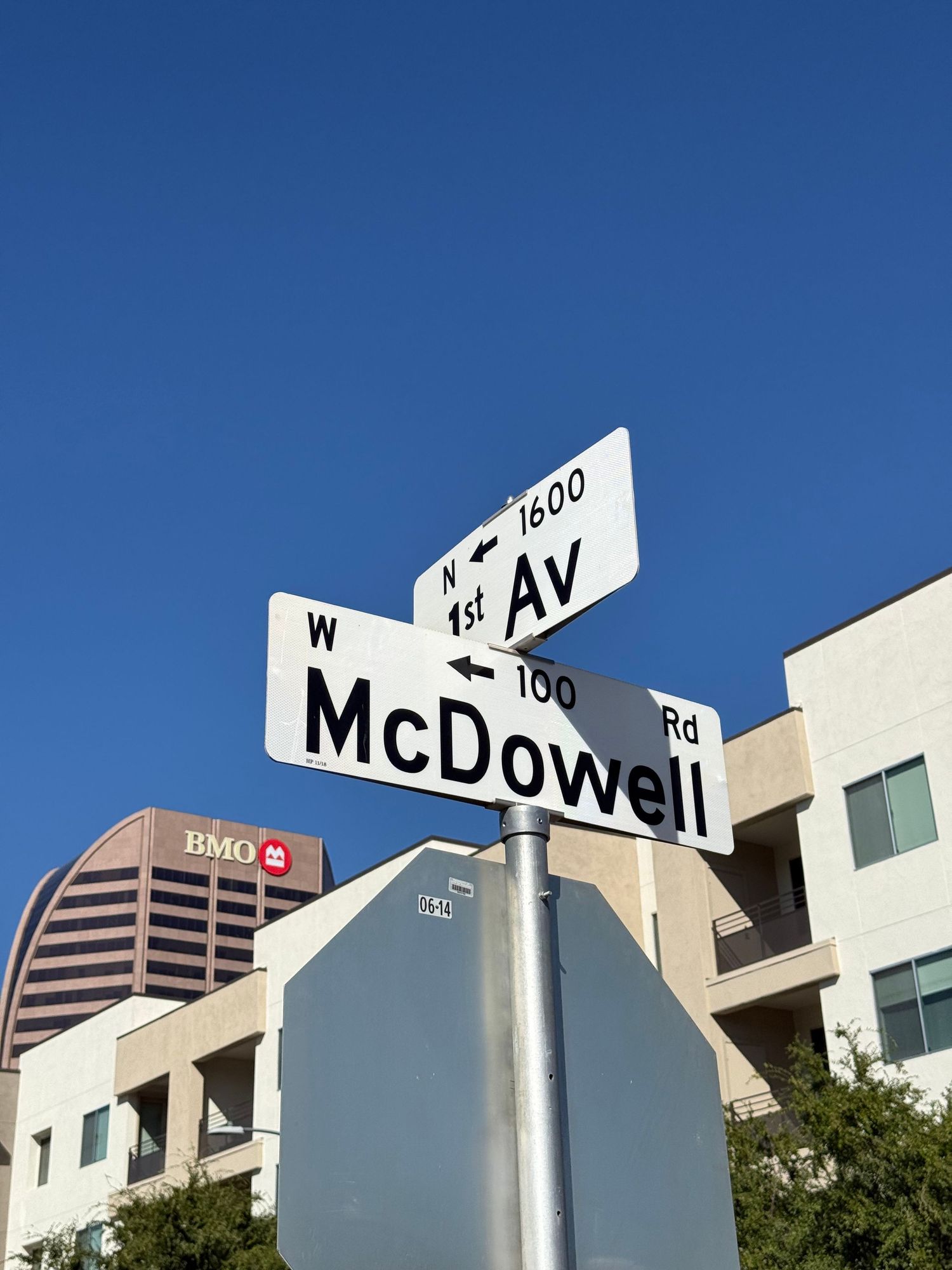 Street sign intersection showing McDowell Avenue against bright blue sky.