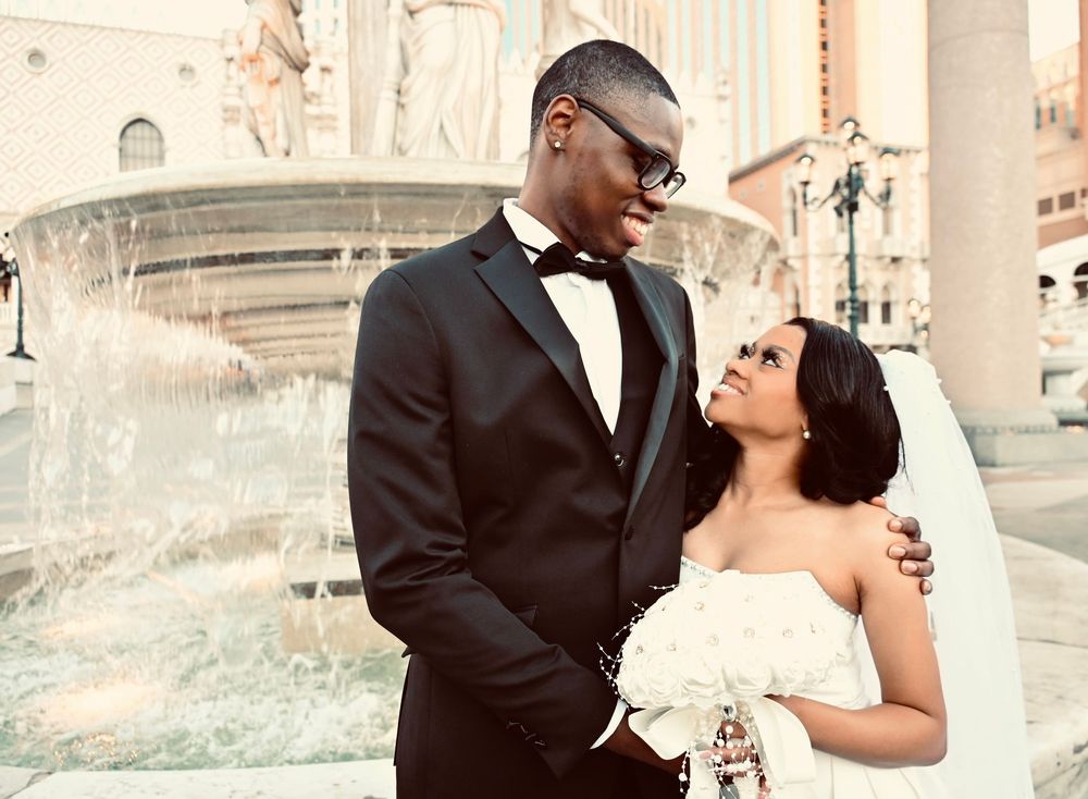 African American wedding couple sharing romantic moment by the Venetian Las Vegas fountain.