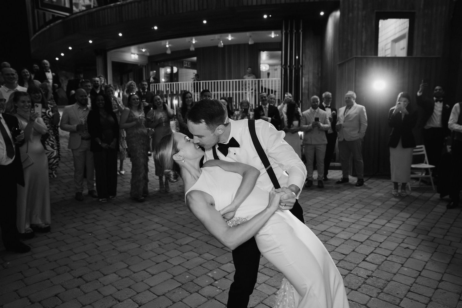 bride and groom sharing kiss during their first dance at tunnels beach wedding venue in north devon