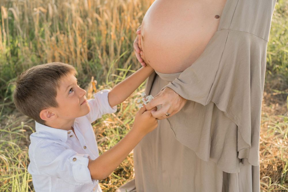 figlio minore tocca pancione mamma, donna incinta, fratelli, sessione fotografica maternity, maternità