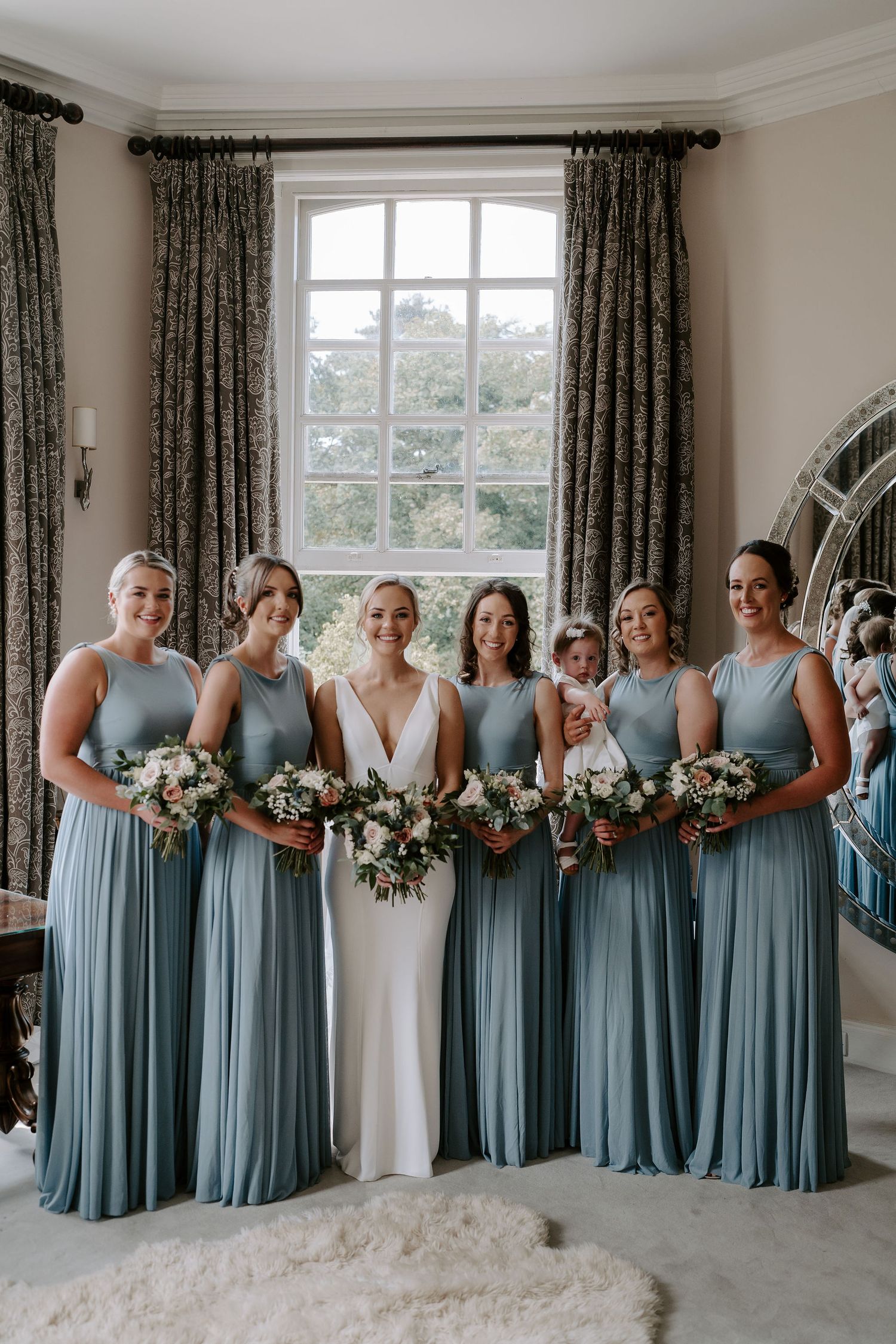 bride and bridesmaids smiling for a portrait at Iscoyd park