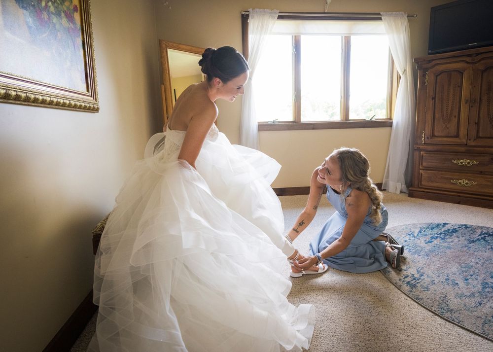 Wedding party getting ready in an elegant room with natural light streaming through windows.