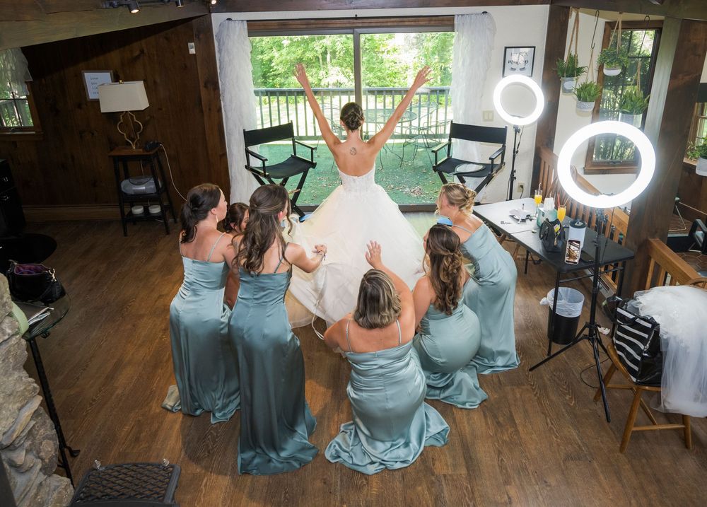 Wedding reception setup with dusty blue bridesmaid dresses and rustic wooden decor.