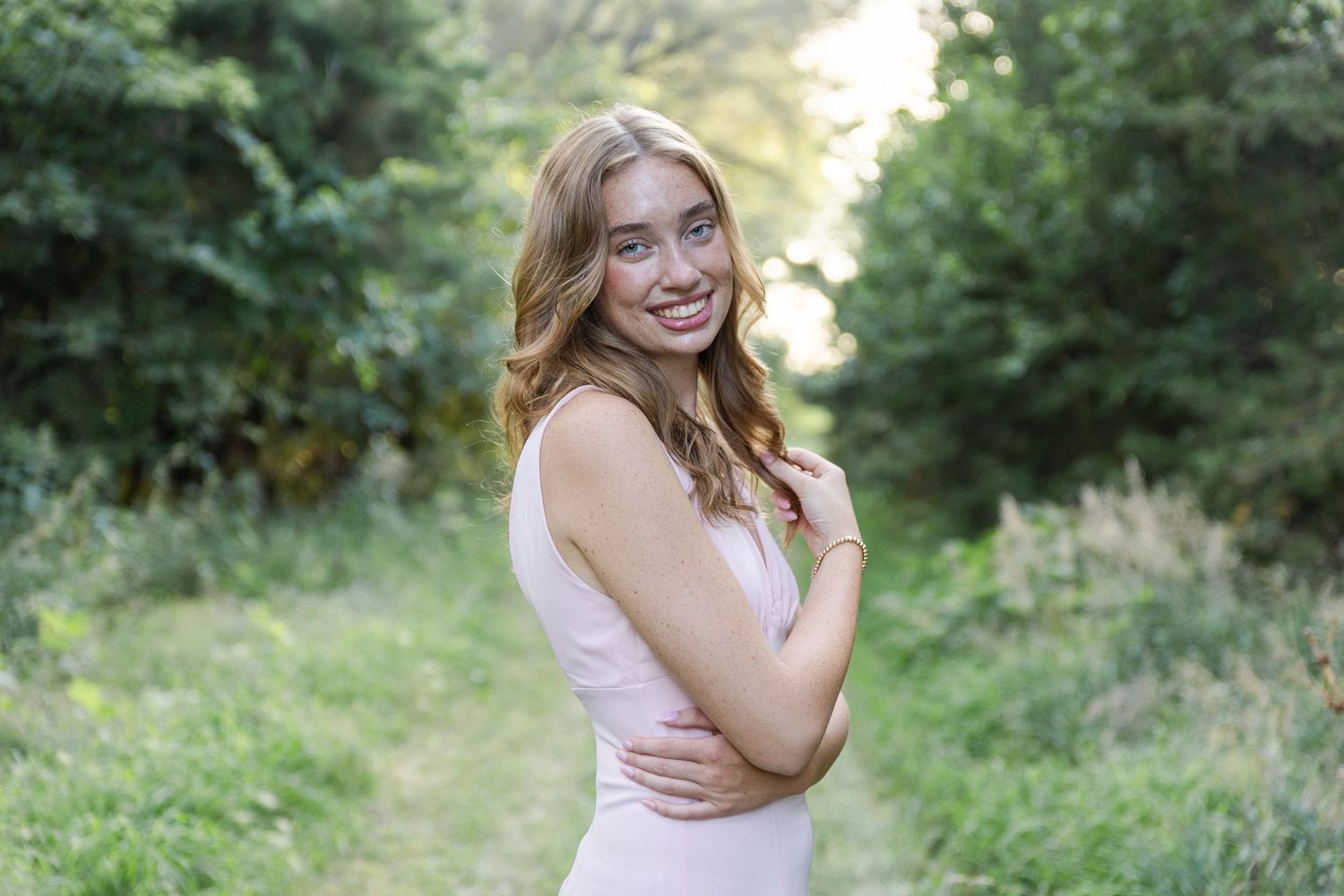 becky katzberg photography senior girl on a grassy path in a pink dress