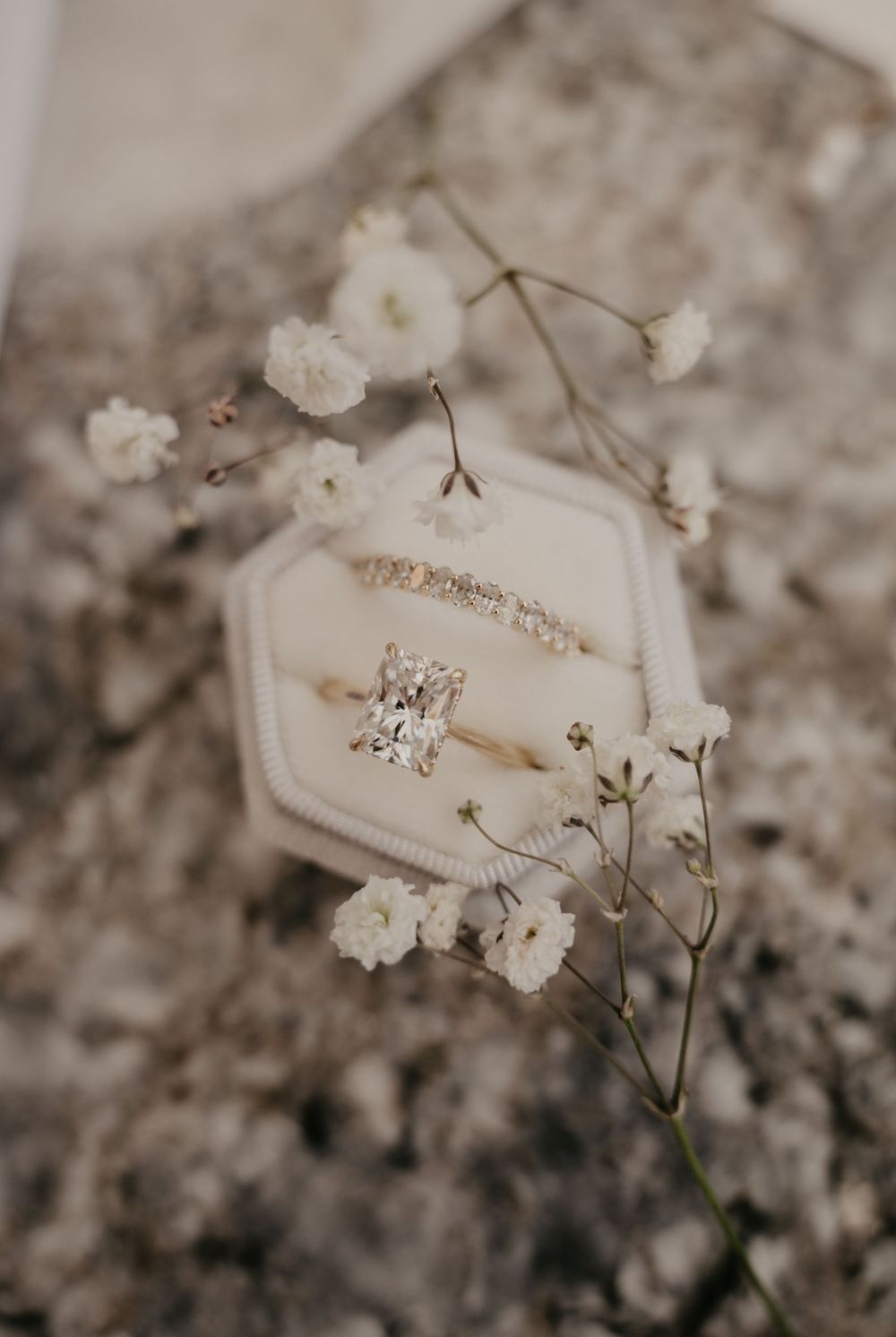 Delicate white baby's breath flowers and lace details create an ethereal wedding detail.