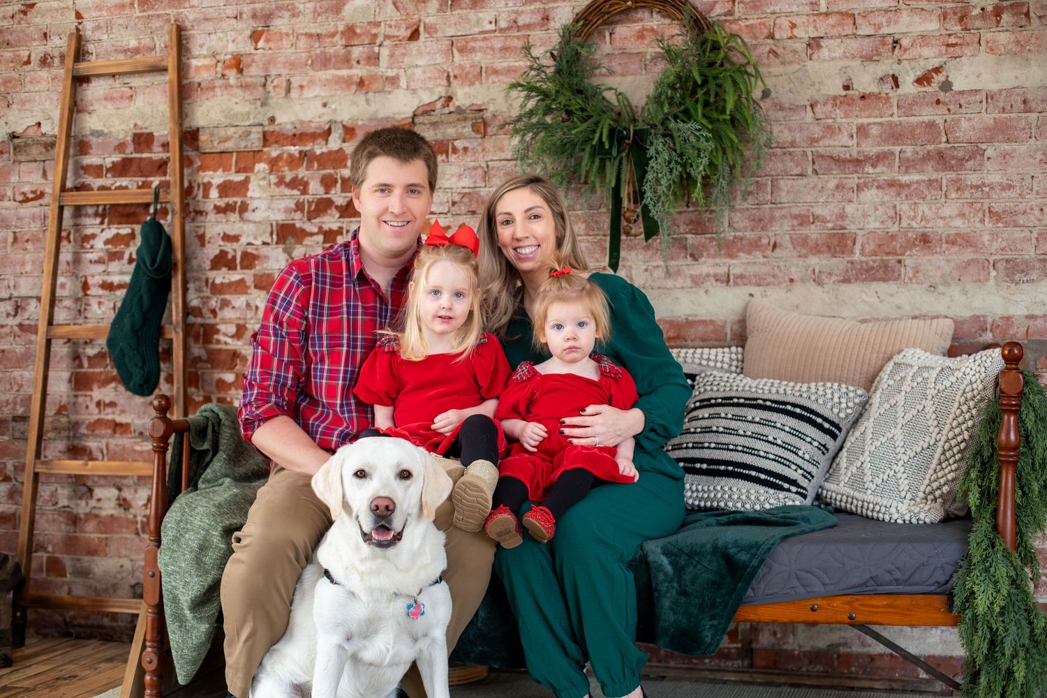 Cincinnati family Christmas photos in Cincinnati featuring family with dog capturing warm holiday lifestyle portraits and festive memories