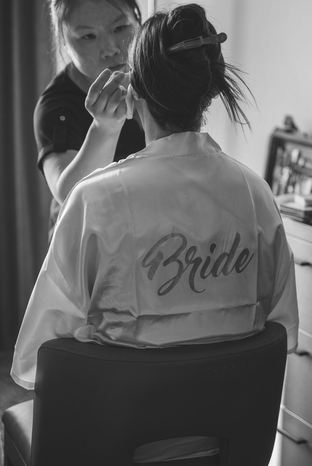 Black and white photo series showing embroidered text on the backs of matching robes.