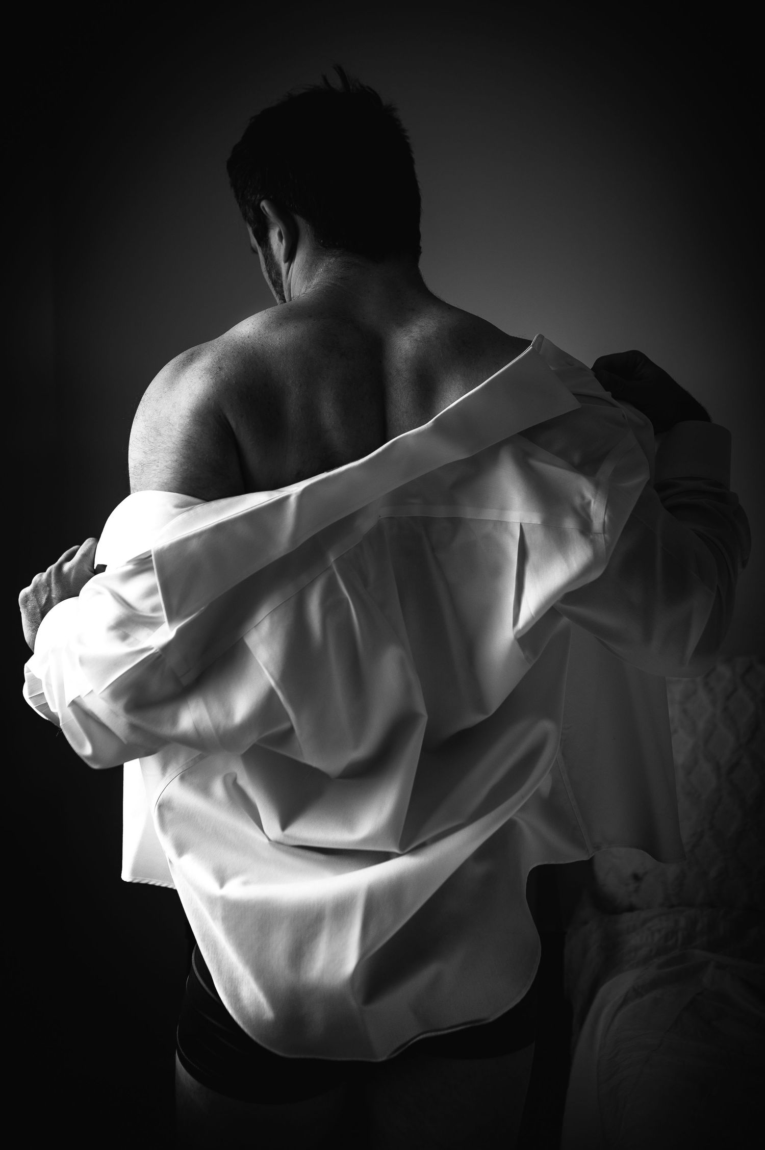 Utah male boudoir photography by Carl James Photography in Salt Lake City, Black and white photo with masculine posing and studio lighting.