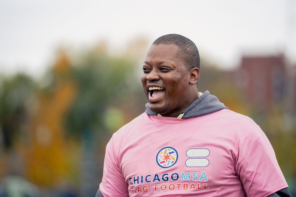 A flag football player in a pink jersey celebrates a successful play in a CMSA game