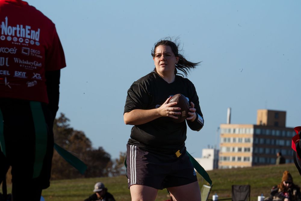 A flag football quarterback looks for passing opportunities