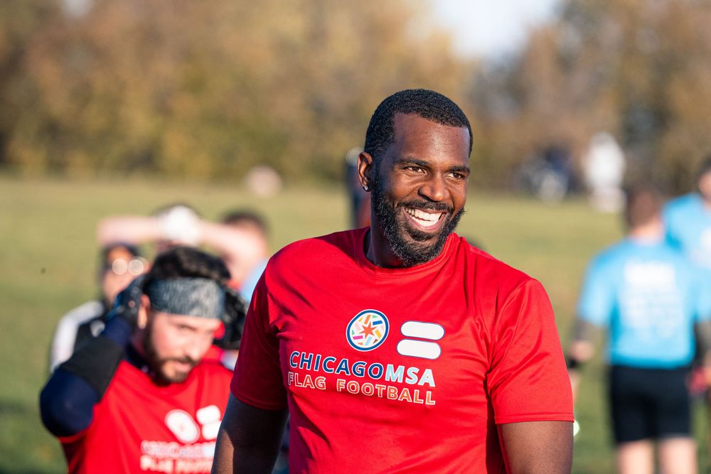 A flag football player in a red jersey celebrates a successful play in a CMSA game