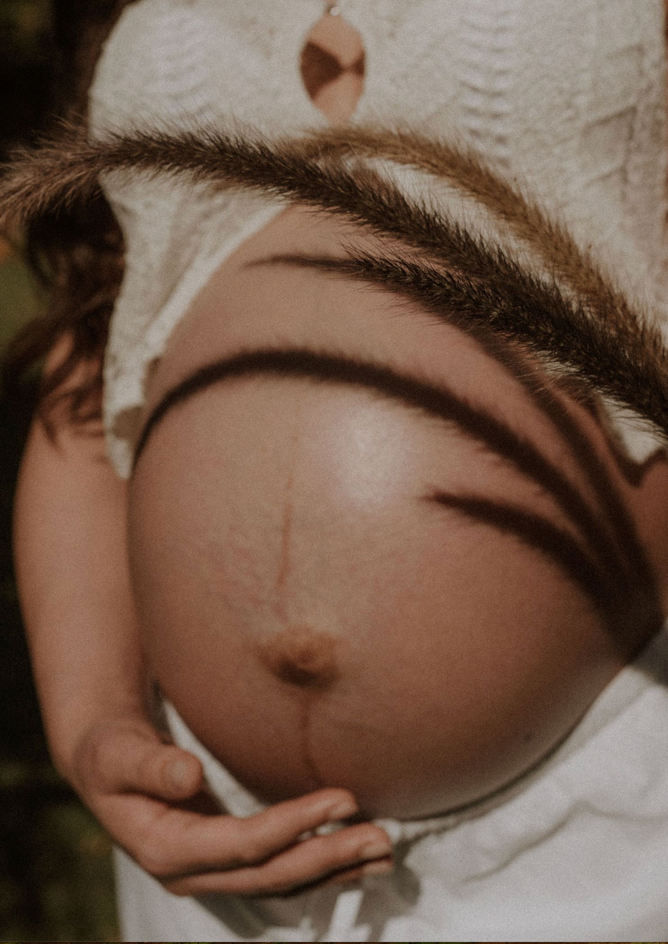 Close-up artistic shots of a pregnant belly with delicate lace details.