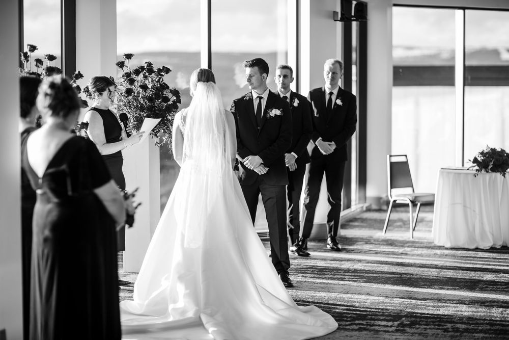 Black and white wedding photo collage showing intimate moments during a ceremony and reception celebration.