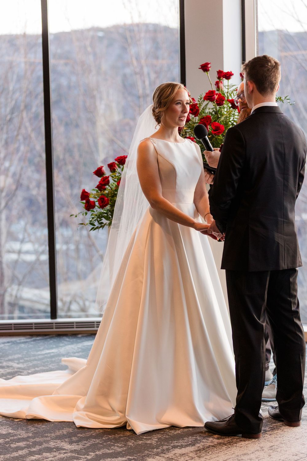 Wedding ceremony sequence showing elegant white bridal gown and formal attire against panoramic winter windows.