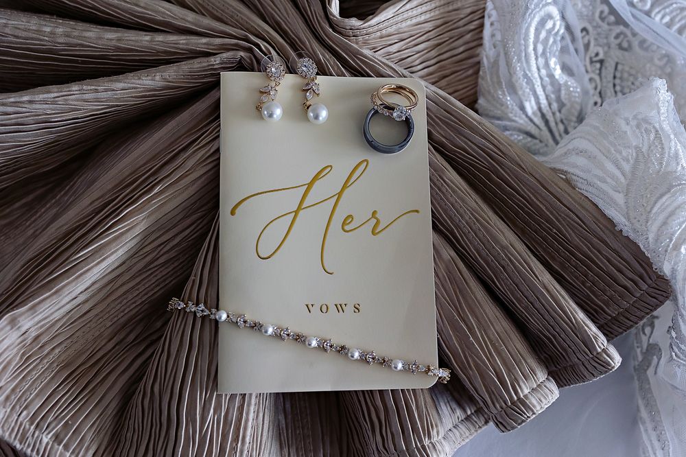 Flat lay details of wedding rings, invitation, and bridal accessories at Moon Palace.
