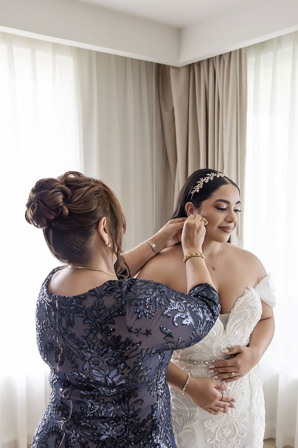 A series of photos showing bridesmaids in navy lace dresses helping with wedding dress preparations.