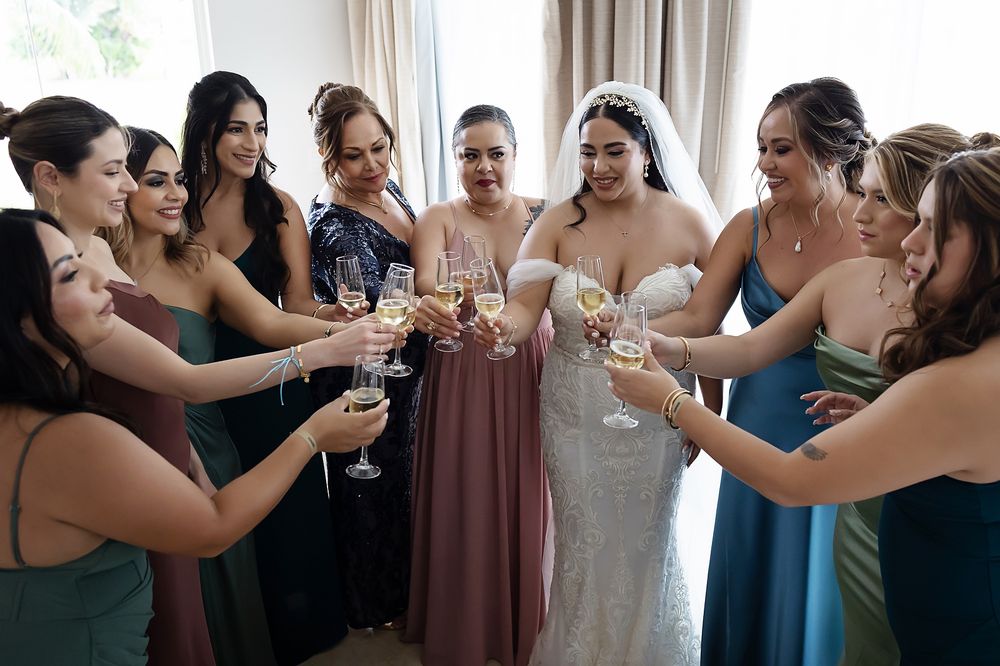 Bridal party celebrating together during getting-ready at Moon Palace in Cancun.