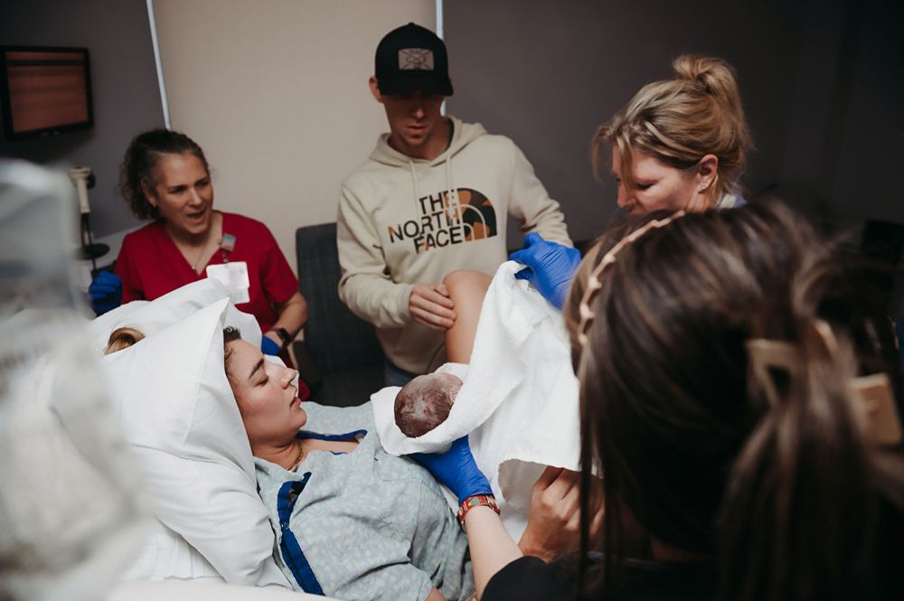 Woman gives birth and baby is laid on her chest for the first time.