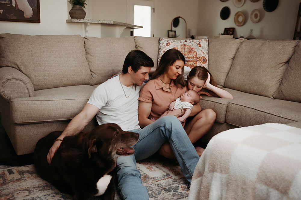 A tender lifestyle photo series showing intimate family moments together on a couch in warm, muted tones.