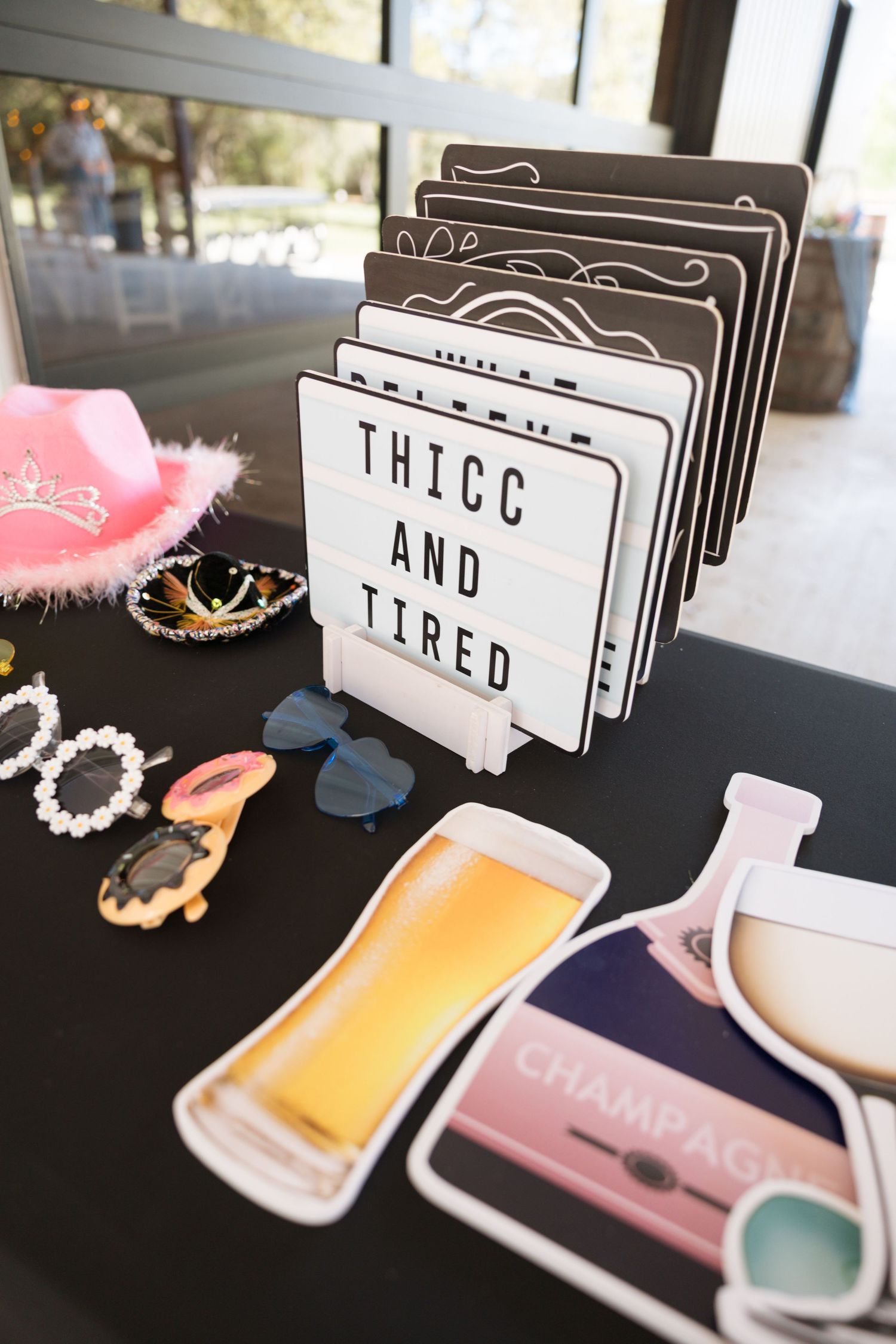 Wedding photo booth props including beer and champagne signs with fun party accessories.