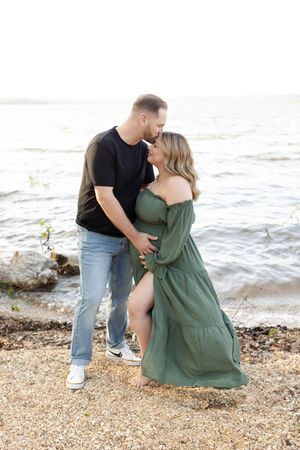 Romantic couple shares intimate moments on a beach shoreline in a series of candid photographs.