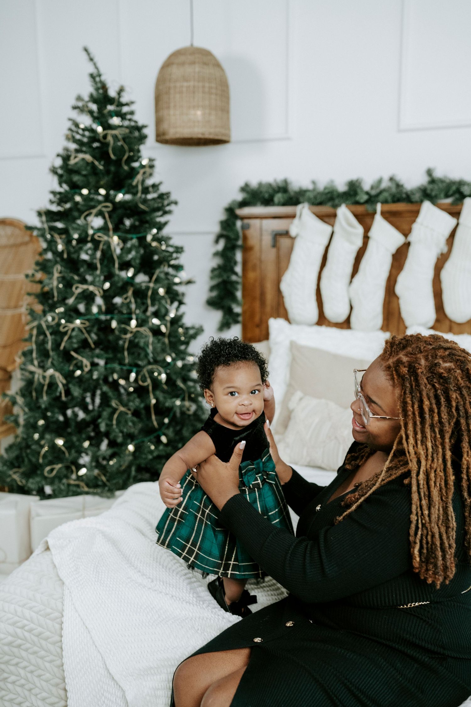 Three cozy holiday photos show a festive living room scene with decorated Christmas trees and white stockings on display.