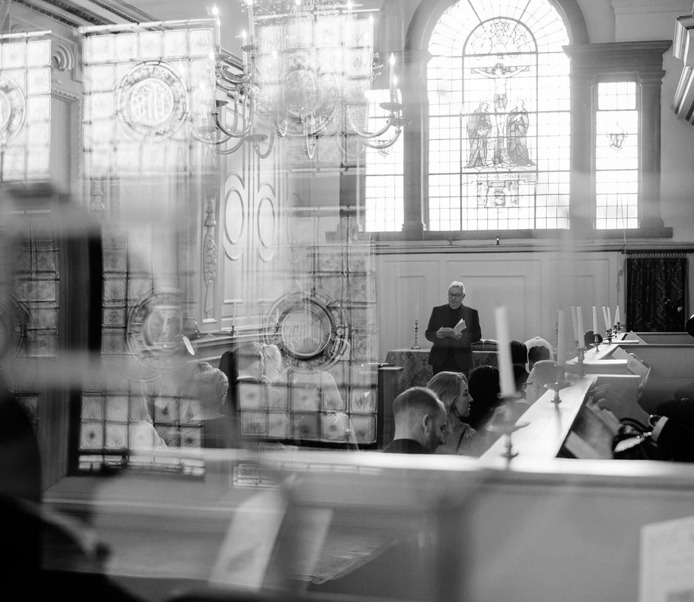 A black and white photo montage showing four interior views of a grand church or cathedral with arched windows.