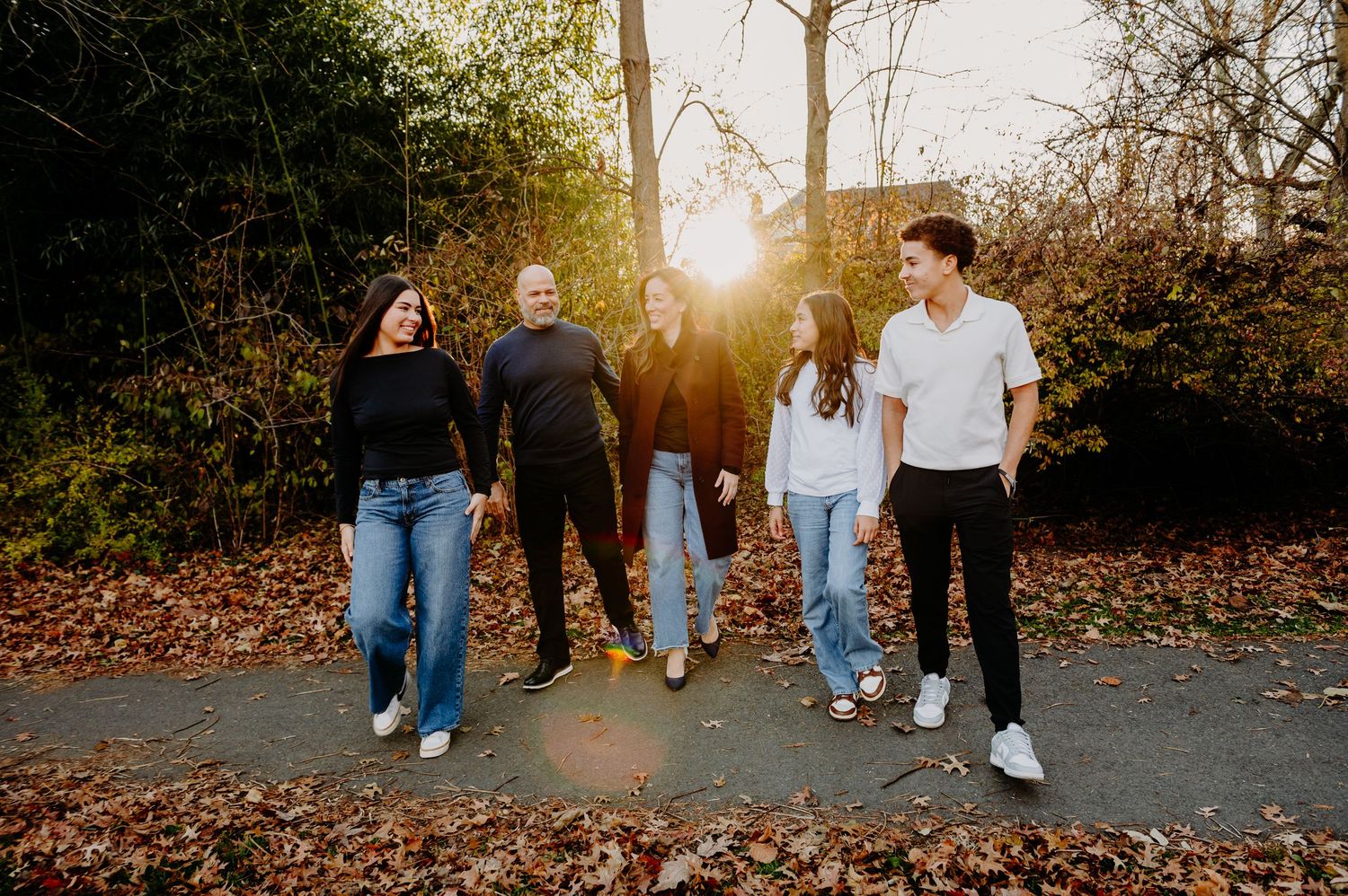Family walking together through a park in the winter time in New Jersey. Family Sessions in New Jersey. Outdoor family photographer.