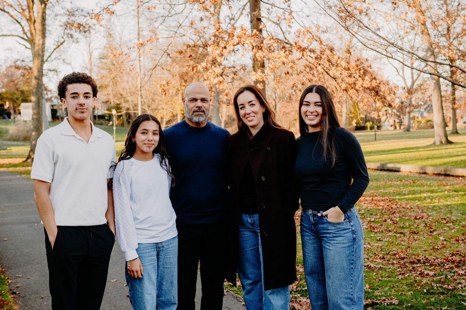Family walking together through a park in the winter time in New Jersey. Family Sessions in New Jersey. Outdoor family photographer.